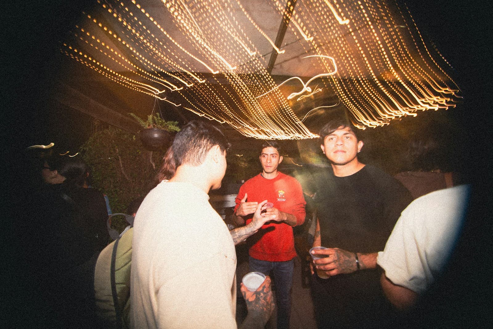 Friends dancing under warm outdoor lights